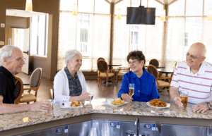 seniors enjoying snacks and drinks at the WhiteStone Senior Living bar